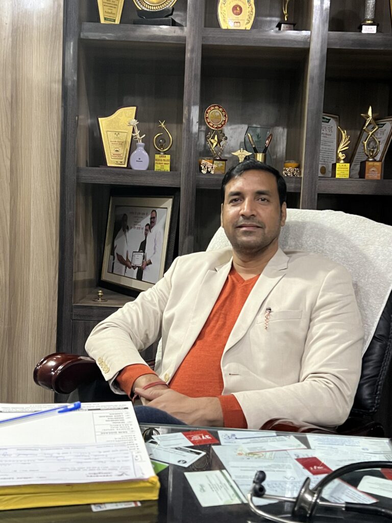 A man in an office chair with papers and a laptop, working diligently in a professional setting.